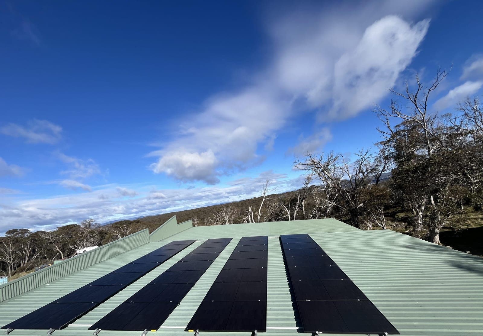 Solar panels on a rooftop under a blue sky